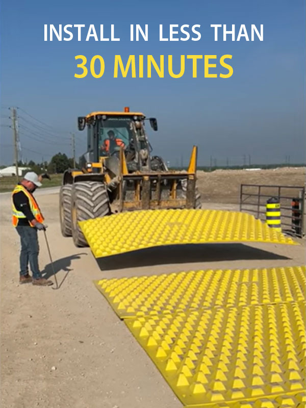 Installing a trackout mat with a loader